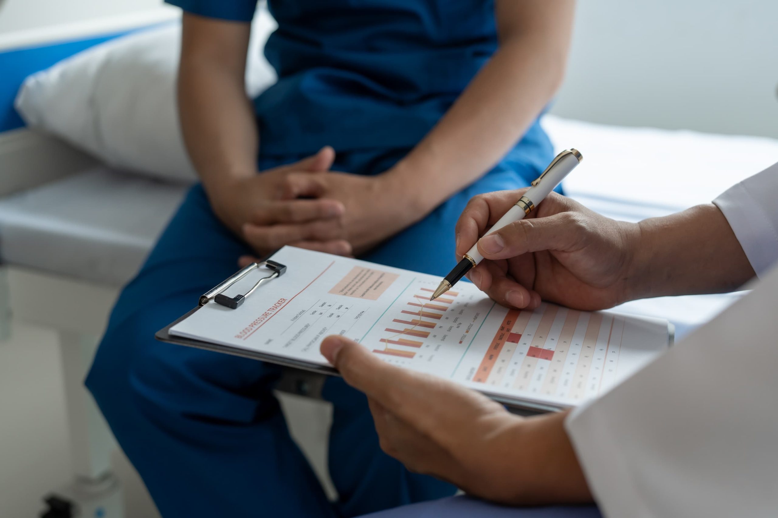 Healthcare professional reviewing diagnostic charts with patient